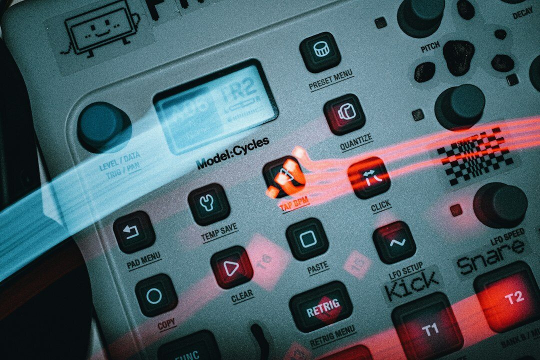 Close-up of a multi-camera video switcher panel with glowing buttons